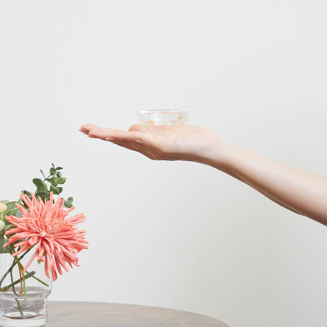 “Nishiki” Gold Flake Guinomi Glass (Clear), on a hand