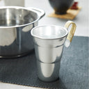 Aluminum Chirori Sake Warmer, on a table